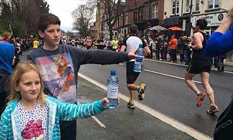 Spectators hand out water at the Sheffield half-marathon.
