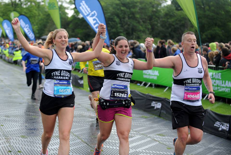Nicola (left) finishing the marathon alongside her sister, Gemma, and Shaun Cowan. (Picture by Jane Barlow)